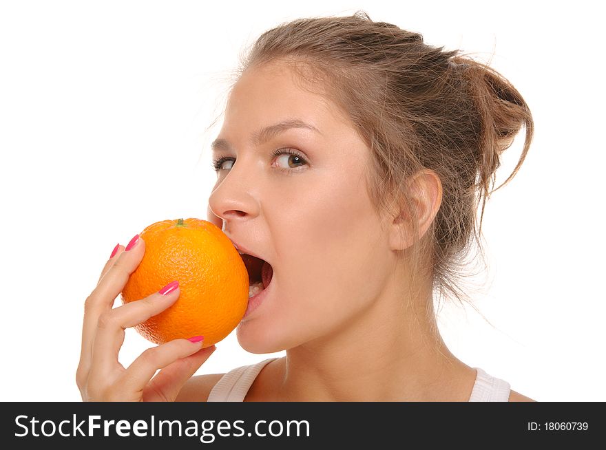 Young woman bites an orange isolated on the white