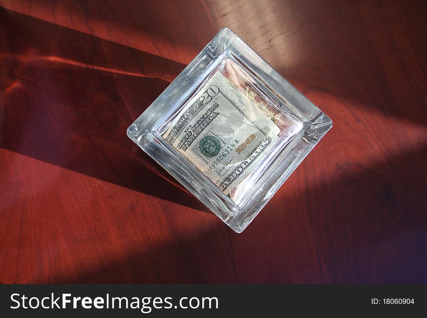 View of money in a glass box. View of money in a glass box.