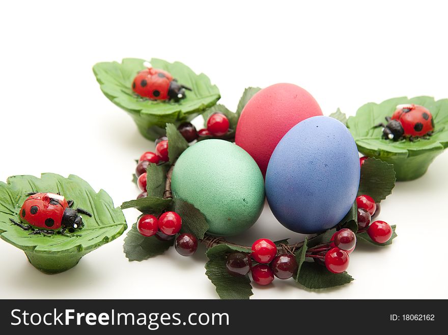 Colored eggs in the wreath with ladybird