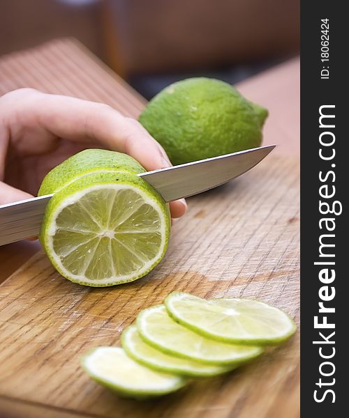 Lemon wait to be cut on a worn butcher block cutting board. Lemon wait to be cut on a worn butcher block cutting board