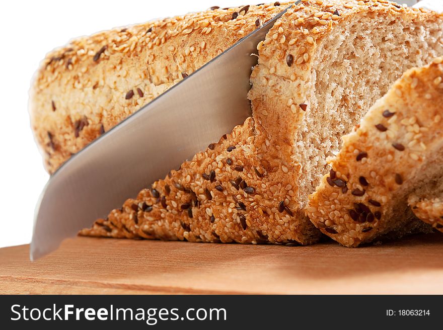 Fresh bread and knife isolated over white