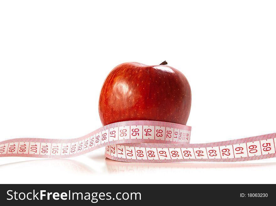 Red apple and tape measure isolated over white