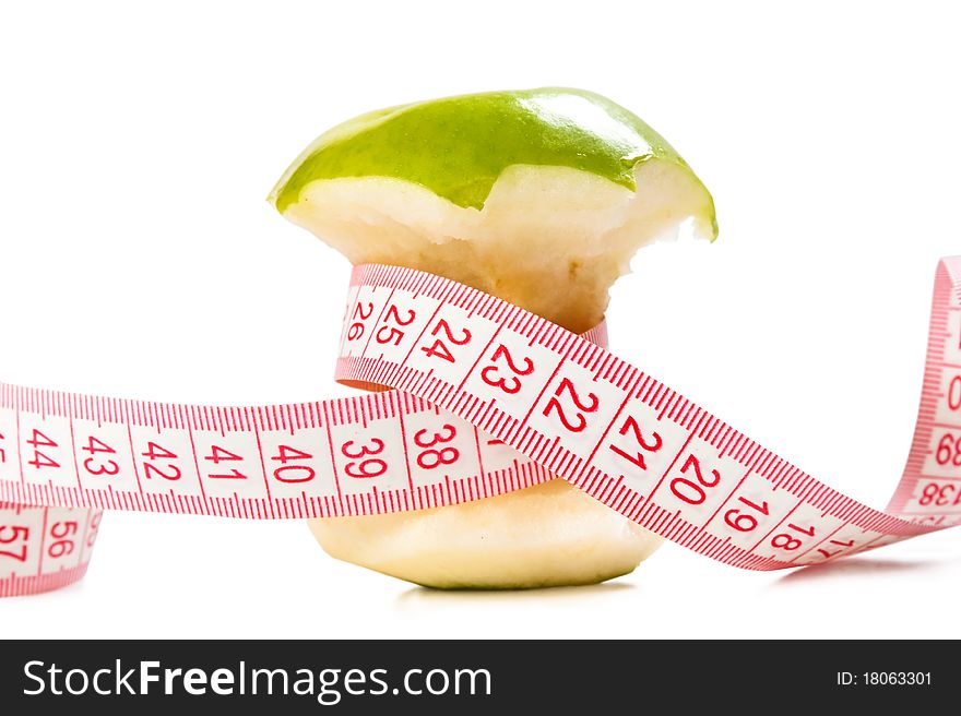 Green apple and tape measure isolated over white