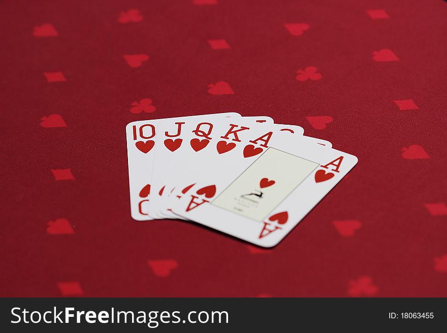 Flush of hearts - Set of 4 official playing poker cards on the casino table