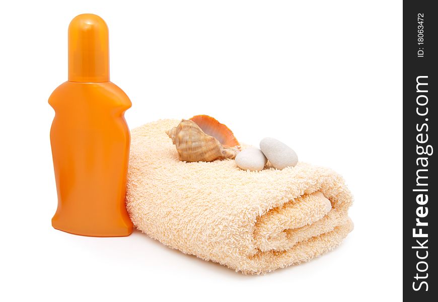 Bath towel with plastic bottle (sunscreen). Isolated on white.