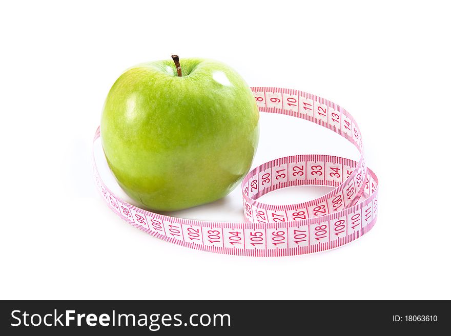 Green apple and tape measure isolated over white