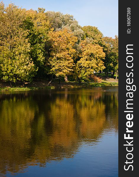 Autumn peaceful lake in the city park. Autumn peaceful lake in the city park