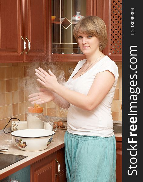 A pretty plump girl preparing pancakes. A pretty plump girl preparing pancakes