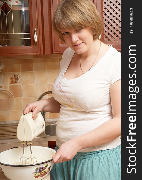 A pretty plump girl preparing pancakes. A pretty plump girl preparing pancakes