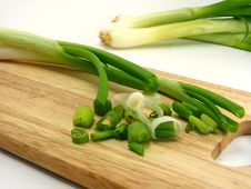 Spring Onions On A Wooden Chopping Board Royalty Free Stock Photos