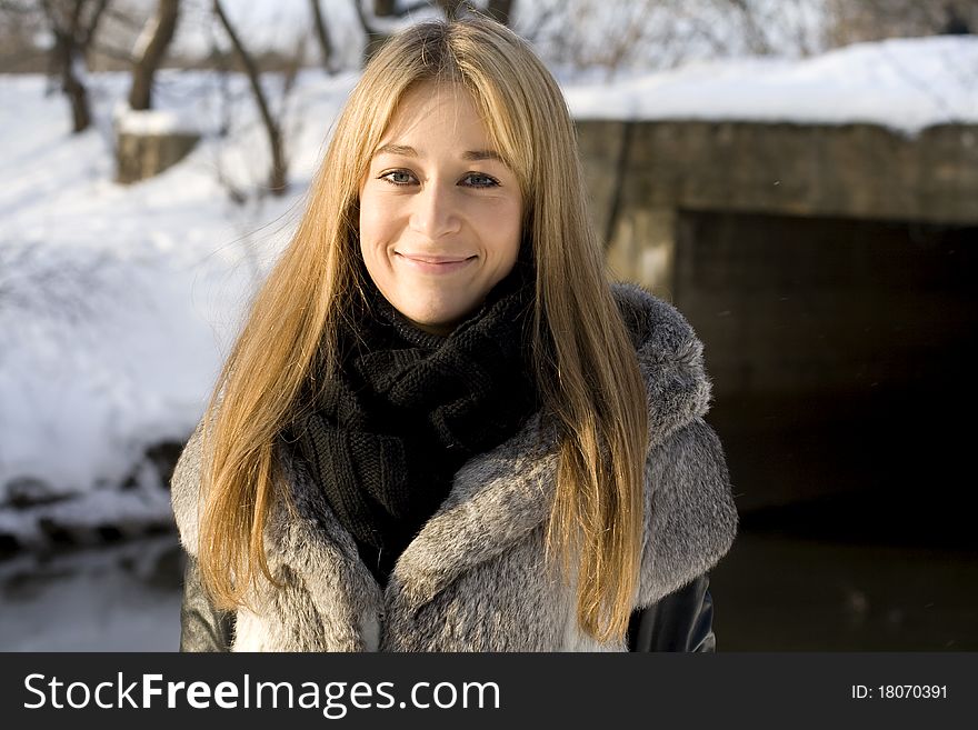 Smiling girl walking in winter forest