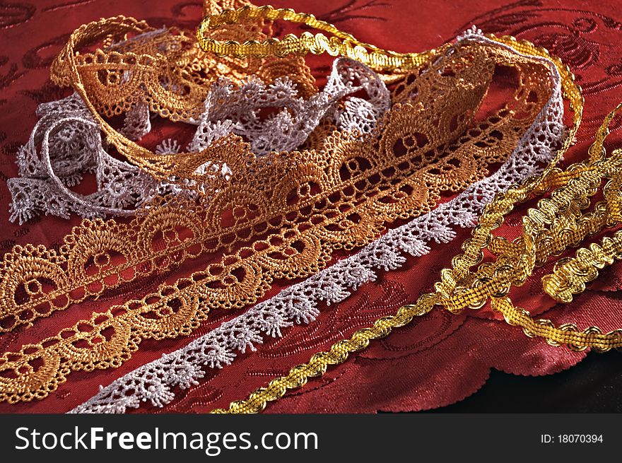 Laces for clothes furnish on a red background