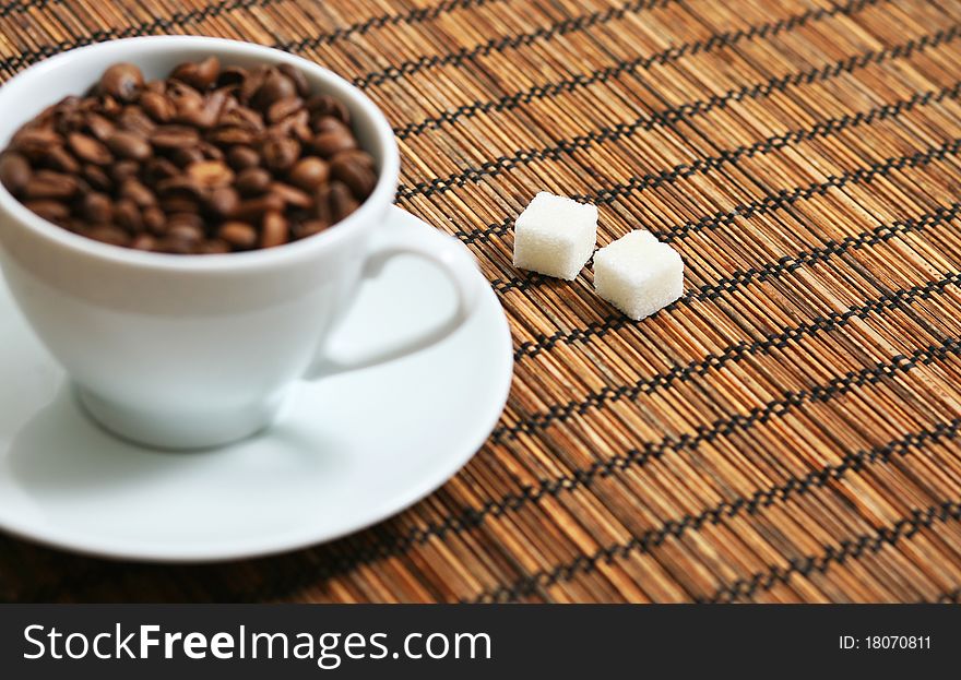 Stock Photo: cup of coffee beans and sugar cubes