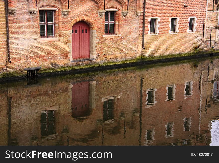 Old buildings reflecting in the canals of Brugge. Old buildings reflecting in the canals of Brugge