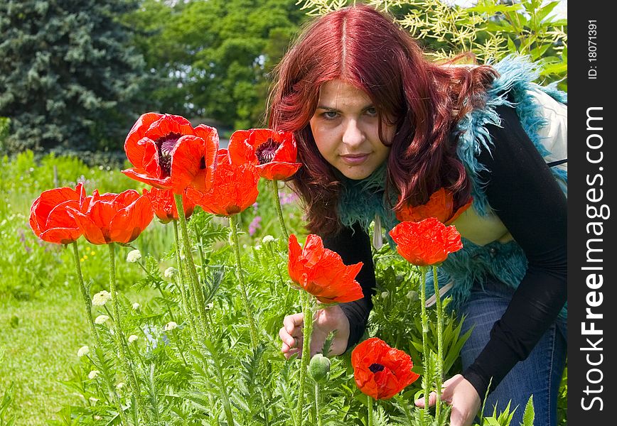 Beautiful woman and red poppies