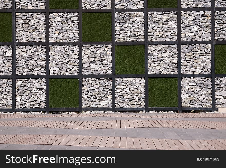 Detail of the wall made from rock and artificial grass