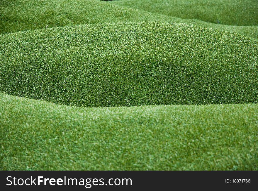 Green artificial grass background close up