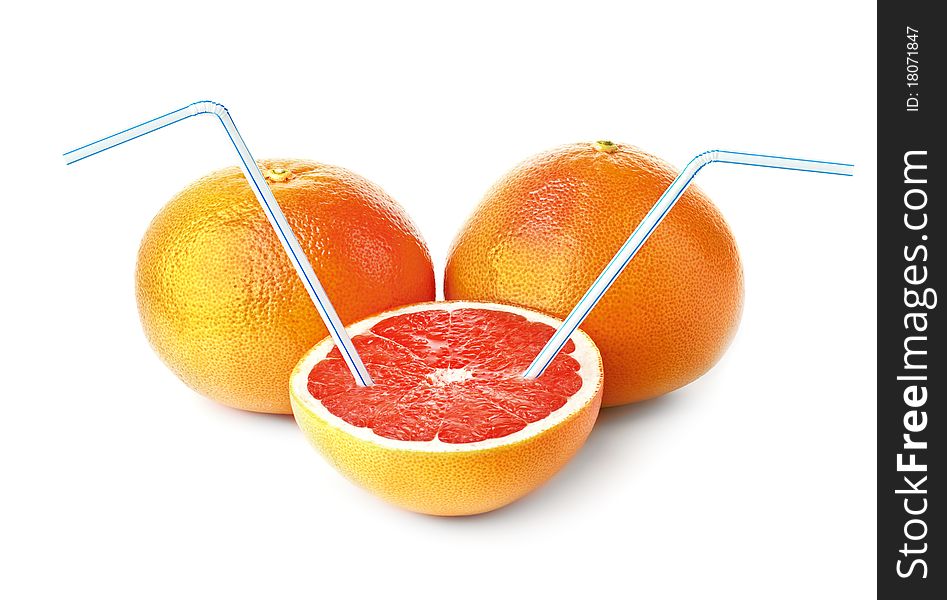 Three juicy grapefruits and cocktail tubes on a white background