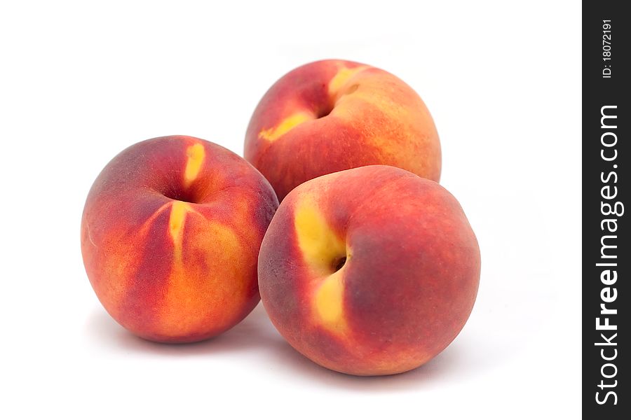 Three orange red peaches  on a white background. Use it for a health or nutrition concept.