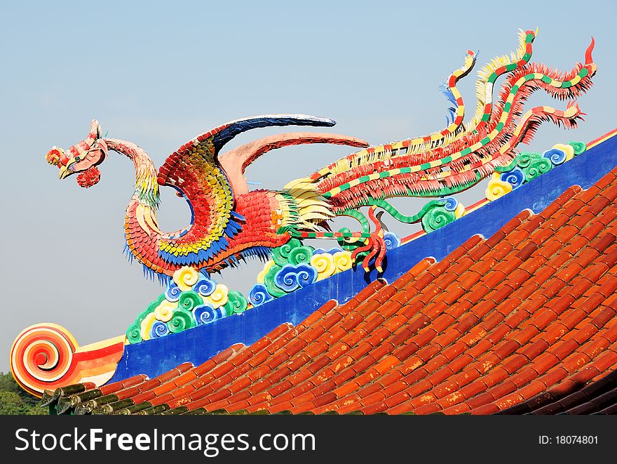 A legend Chinese sea bird sculpture on the roof with blue sky