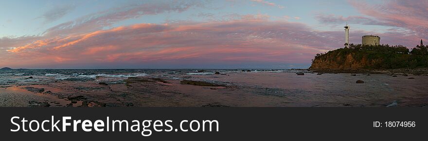 Panoramic banner of a rocky beach & lighthouse on a cliff. Panoramic banner of a rocky beach & lighthouse on a cliff