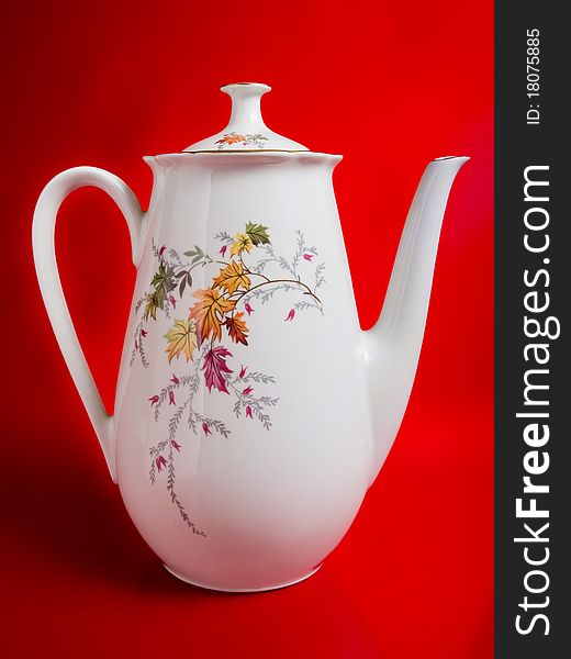 Big white kettle isolated on red - lit a soft. Big white kettle isolated on red - lit a soft
