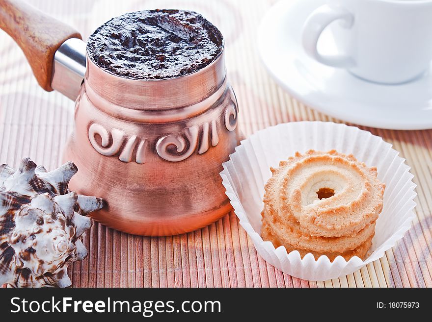 Turkish coffee in copper coffee pot and cookies