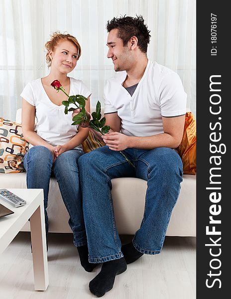 Young boy giving red rose to a beauty girl