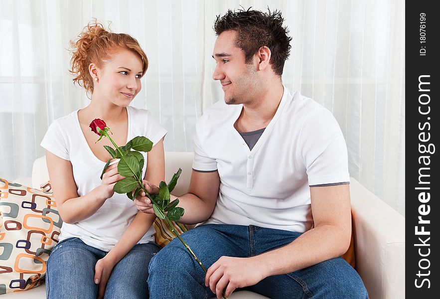 Young Boy Giving Red Rose To A Beauty Girl