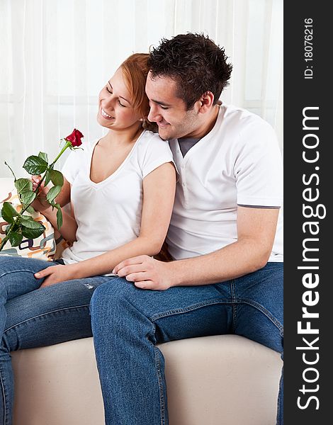 Young boy and a beauty, young girl with red rose