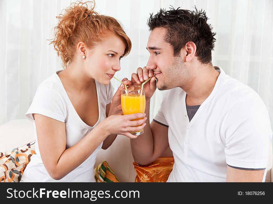 Young Boy And A Beauty Girl Drinking Ora