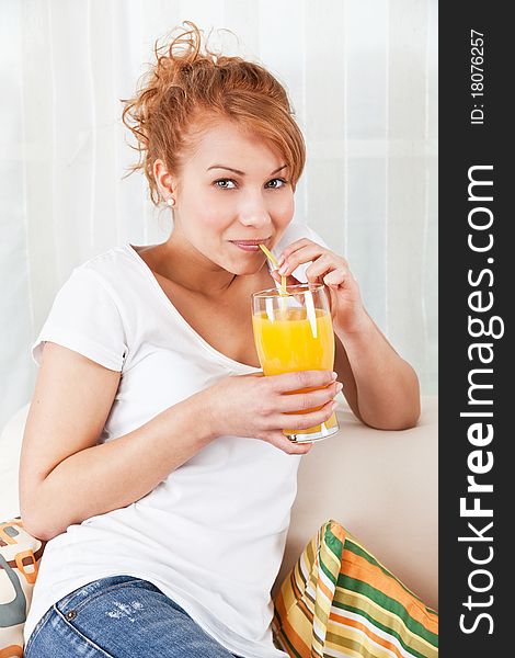 Beauty, young girl drinking a glass of orange juice