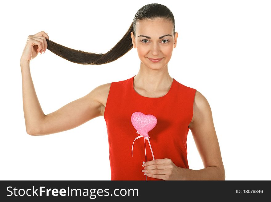 Young elegant female in red holding heart shape and her ponytail isolated on white. Young elegant female in red holding heart shape and her ponytail isolated on white