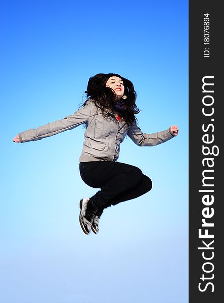 Happy beautiful Jumping Girl on blue sky. Happy beautiful Jumping Girl on blue sky