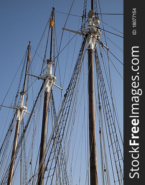 Rigging on ship without sails against blue sky background. Rigging on ship without sails against blue sky background