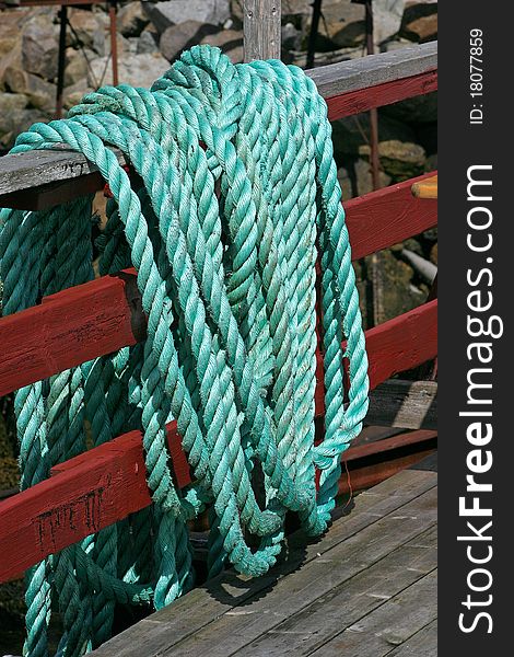 Green ship rope hanging on a fence. Green ship rope hanging on a fence