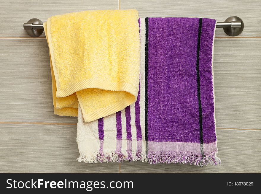 Purple and yellow towels in the bathroom