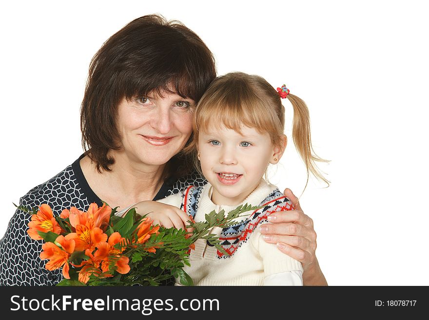Grandmother and granddaughter with bunch of flower