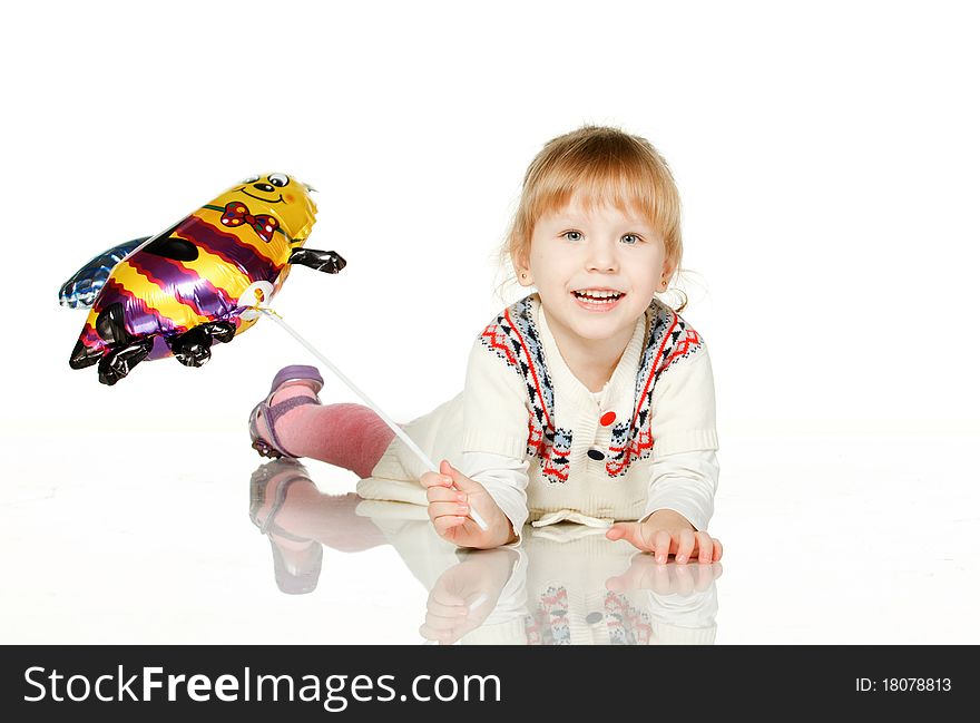 Kid lying on the floor with balloon bee