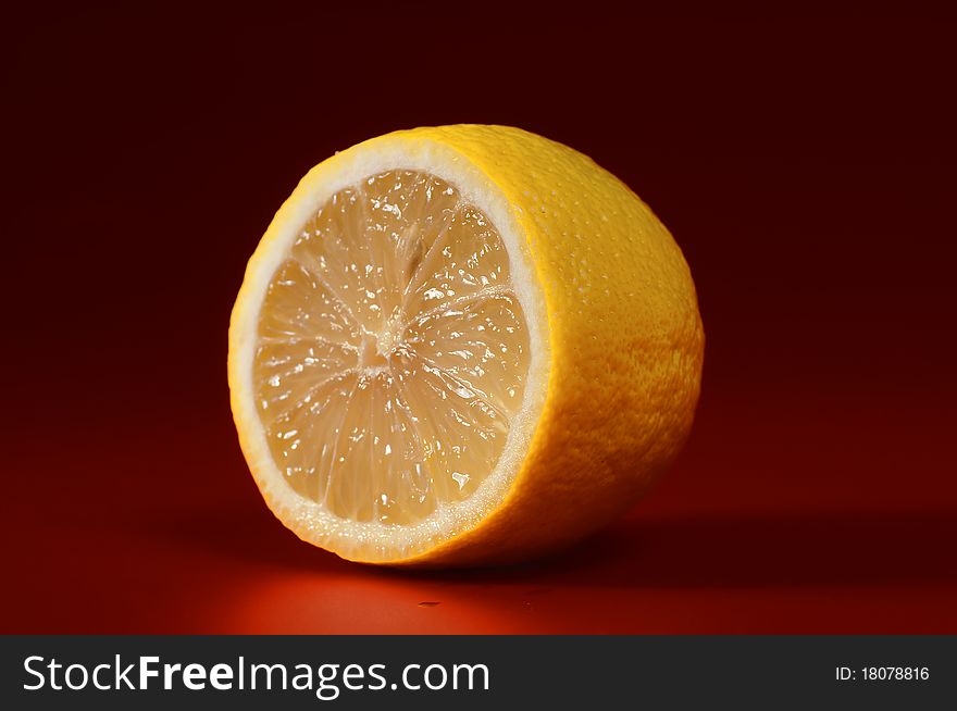 Fresh lemon on a red background