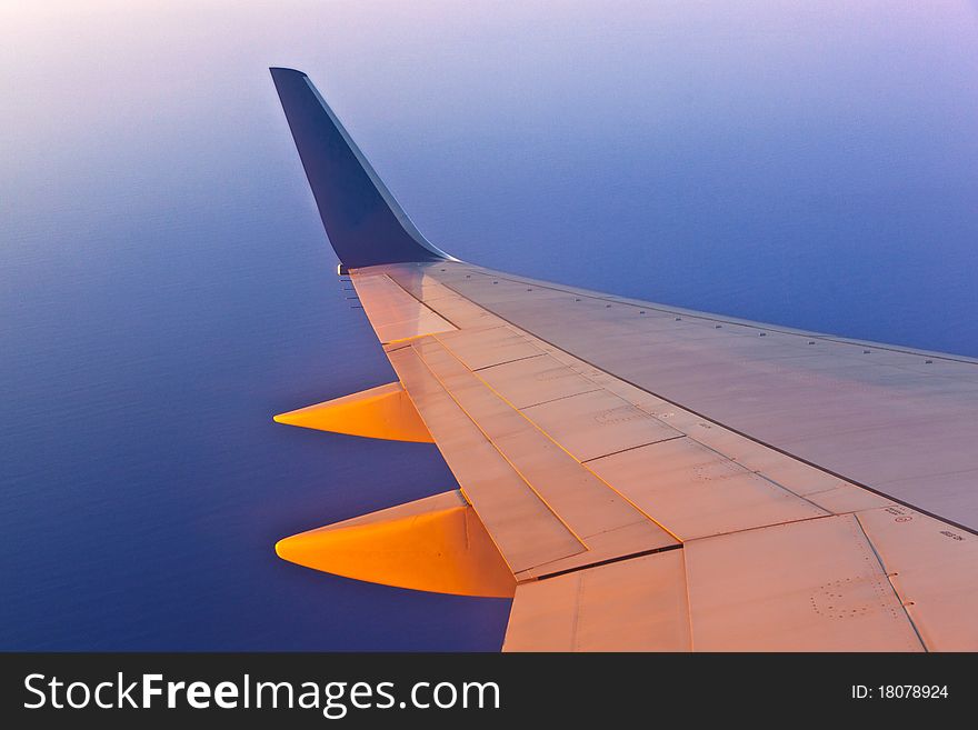 Wing of aircraft in sunset