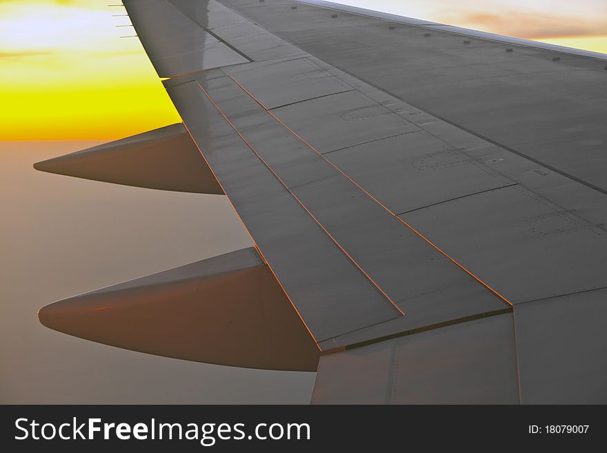Wing of aircraft in sunset
