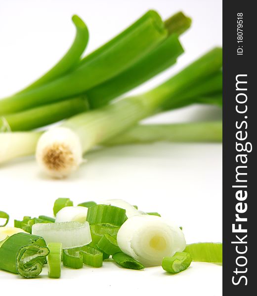 Chopped spring onions with whole onions faded in background DOF. Chopped spring onions with whole onions faded in background DOF