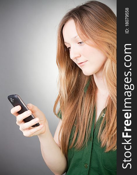 Image of Beautiful Woman Using her Mobile, with grey background