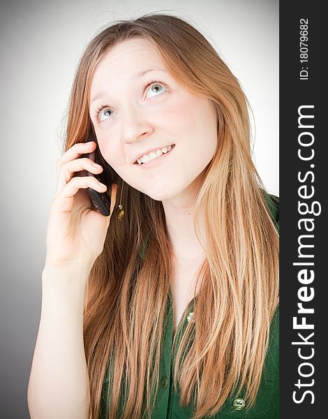 Image of Beautiful Woman Using her Mobile, with grey background