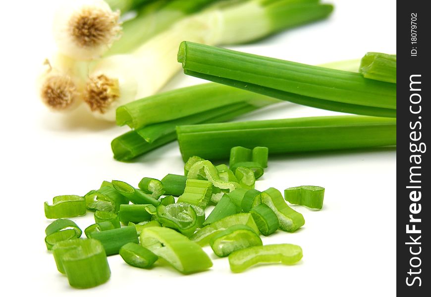 Chopped spring onions with whole onions faded in background DOF. Chopped spring onions with whole onions faded in background DOF