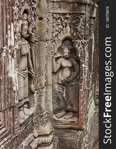 Ancient sculpture on the stone walls of the temple Apsaras at Angkor Wat, Cambodia