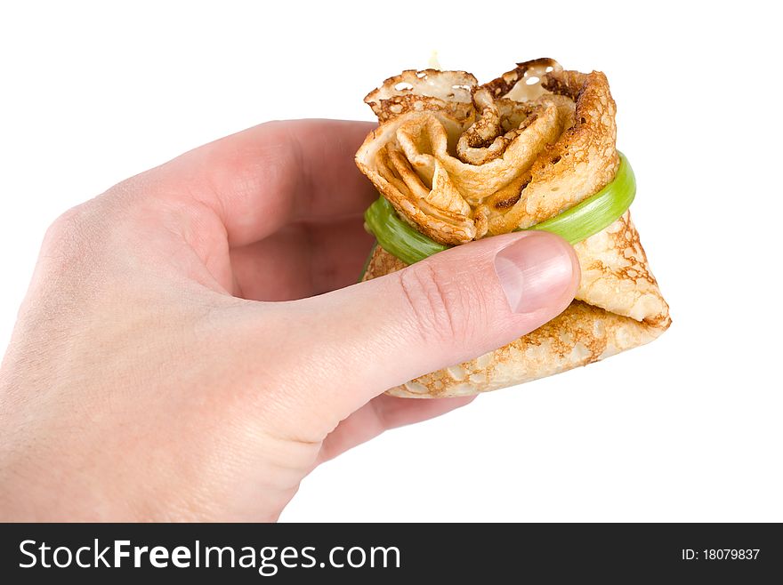 Pancake in hand isolated on white background