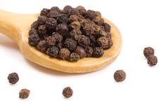 Black Peppercorns On A Wooden Spoon Stock Image