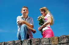 Young Woman With Flowers And Her Boyfriend Stock Images Young Woman With Flowers And Her Boyfriend Stock Images